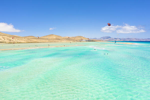 Kitesurf flying on ocean waves at Sotavento beach (Playa de Sotavento de Jandia), Fuerteventura, Canary Islands, Spain