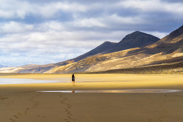 Woman admiring mountains from Cofete Beach, Jandia natural park, Fuerteventura, Canary Islands, Spain