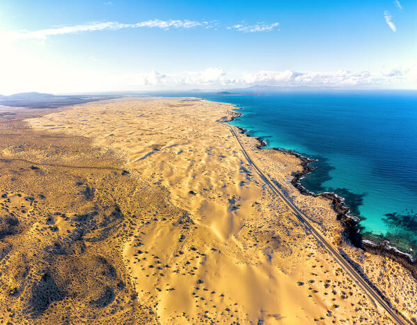Aerial view of desert sand dunes beside the ocean in Corralejo Natural Park,  Fuerteventura, Canary Islands, Spain