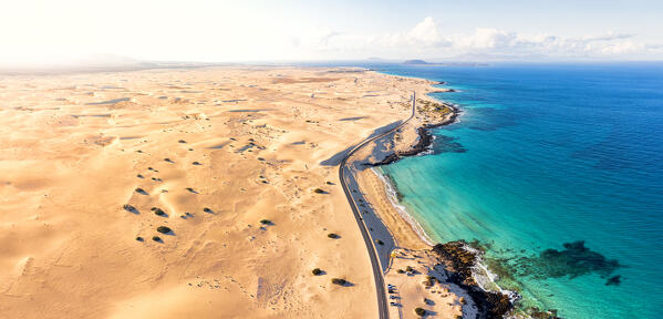 Aerial view of scenic road running beside the sand dunes of Corralejo Natural Park, Fuerteventura, Canary Islands, Spain