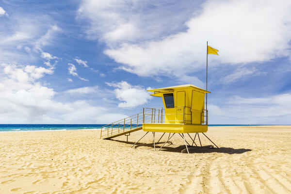 Yellow hut of lifeguard on sand beach by the ocean, Morro Jable, Fuerteventura,  Canary Islands, Spain