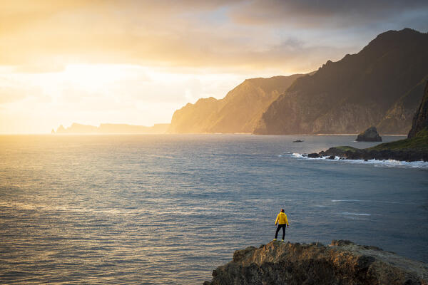 Man admiring the ocean from top of cliffs from Miradouro Do Guindaste viewpoint, Faial, Madeira island, Portugal (MR)