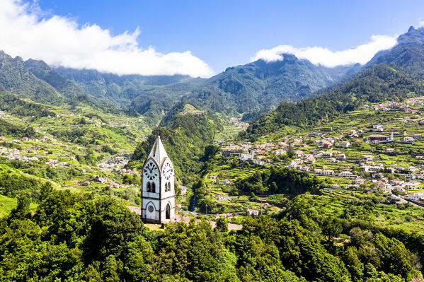Clock-tower of Nossa Senhora de Fatima chapel and village in the lush vegetation, Sao Vicente, Madeira island, Portugal