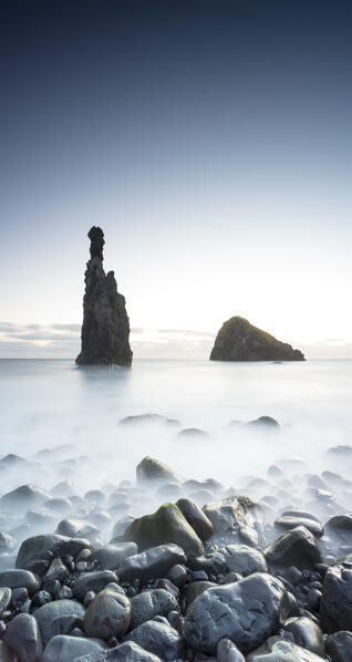 Dusk over Ilheus da Rib and Ribeira da Janela rock formations and volcanic stone beach, Porto Moniz, Madeira, Portugal