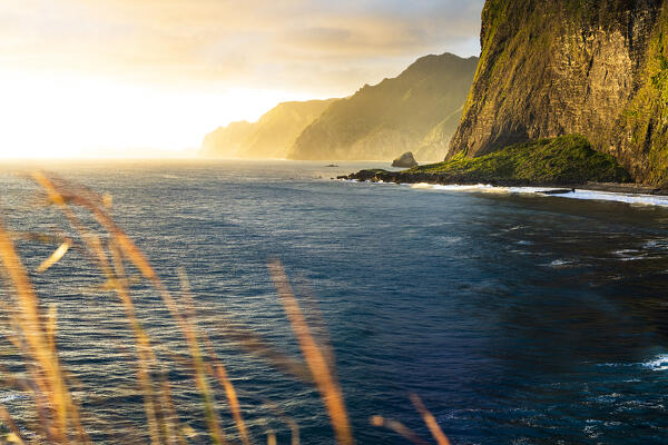Majestic cliffs at Miradouro Do Guindaste viewpoint lit by the warm sunrise, Faial, Madeira island, Portugal