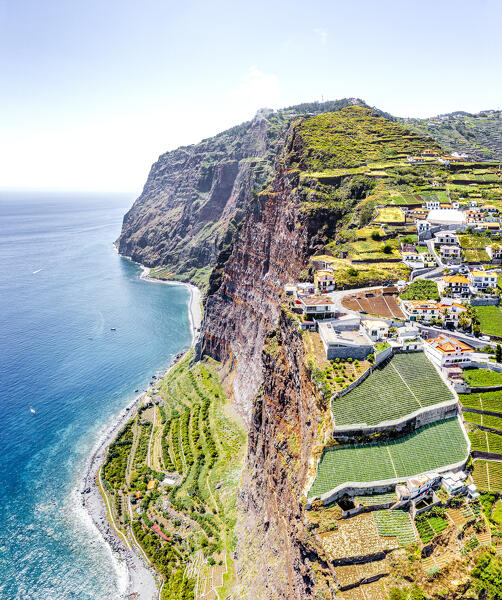 Camara de Lobos town and Rancho cableway on rocky mountain above the ocean, Madeira island, Portugal