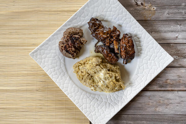 Dish of polenta taragna with sausage and pork ribs, Italy