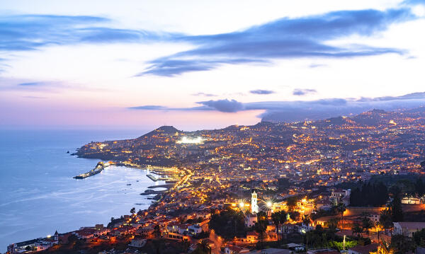 High angle view of Funchal city and bay at dusk from Sao Goncalo, Madeira island, Portugal