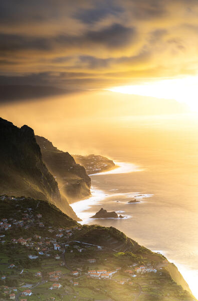 Warm sunset over Arco de Sao Jorge and Ponta Delgada on cliffs above the ocean, Madeira island, Portugal