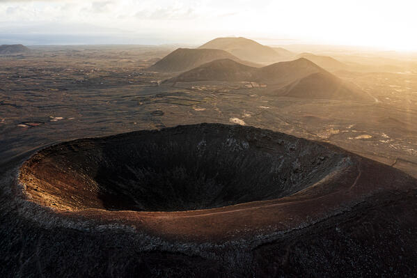 Aerial view of sunrise over the crater of Hondo volcano (Calderon Hondo), Corralejo, Fuerteventura, Canary Islands, Spain