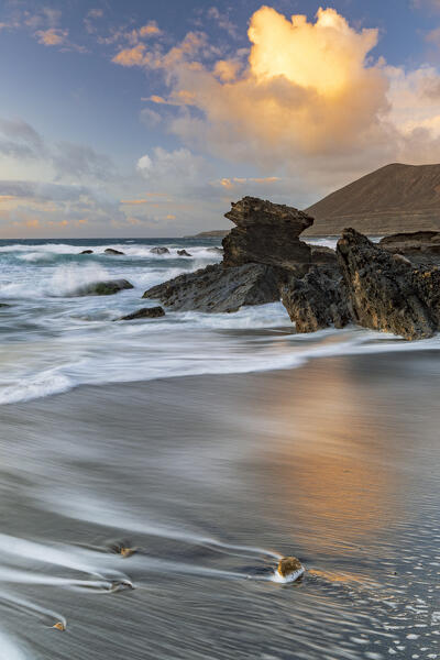 Sunset clouds over the rough sea at Playa de la Solapa beach, Pajara, Fuerteventura, Canary Islands, Spain