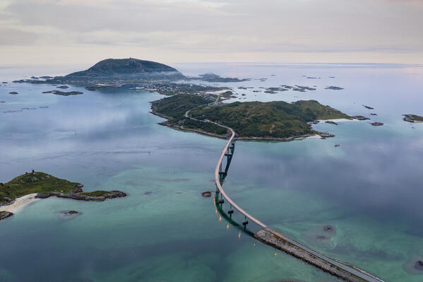 Winding course of Sommaroy bridge crossing the calm sea, aerial view, Sommaroy, Troms county, Northern Norway