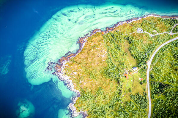 Road crossing the green landscape of Bergsoyan Islands washed by crystal sea from above, Skaland, Senja, Troms county, Norway
