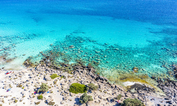 Crystal sea washing the white sand of Kedrodasos beach, not far from famous Elafonisi lagoon, southwest Chania, Crete, Greece