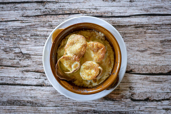 Bowl of Manfrigole crepes of Taroz with bechamel and Porcini mushrooms, traditional food of Valtellina, Lombardy, Italy