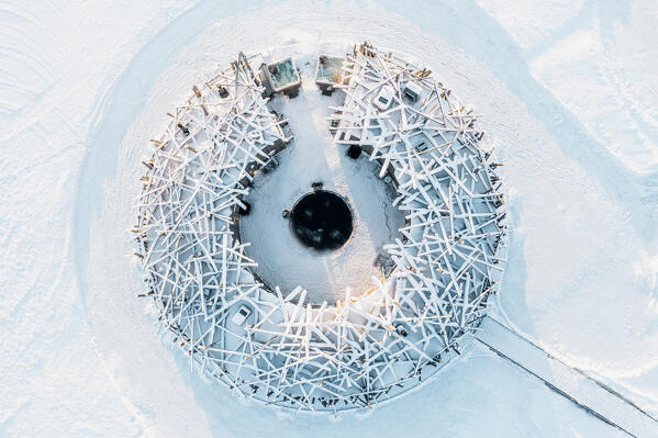 Frozen circular building made with timber covered by snow from above, Arctic Bath Spa Hotel, Harads, Lapland, Sweden