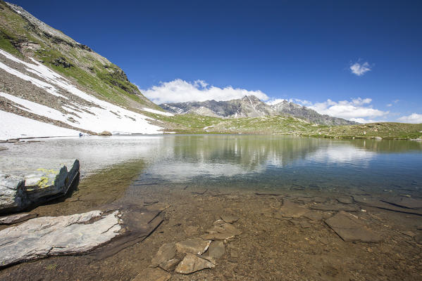 The peaks of Vallespluga reflected in Lago Bianco at Pian dei Cavalli. Pian dei Cavalli, Campodolcino, Vallespluga, Valchiavenna, Lombardy, Italy.