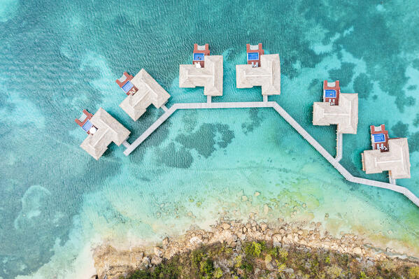 Overhead view of luxury tourist resort with overwater bungalows in the crystal water of Caribbean Sea, Antigua, West Indies