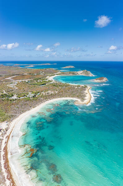 Clear summer sky over the white sand beach overlooking the crystal water of Caribbean Sea, aerial view, Antigua, West Indies