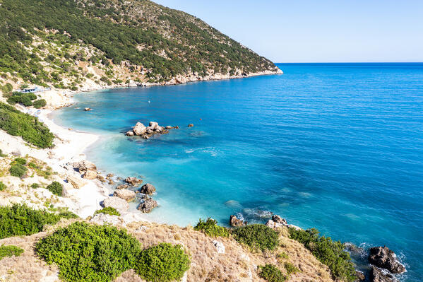 Turquoise clear sea washing the empty Vouti beach framed by trees,  Zola, Kefalonia, Ionian Islands, Greece