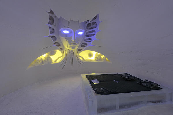 Artistic ice sculptures in shape of an alien face in a hotel suite, Lainio Snow Village, Kittila, Lapland, Finland