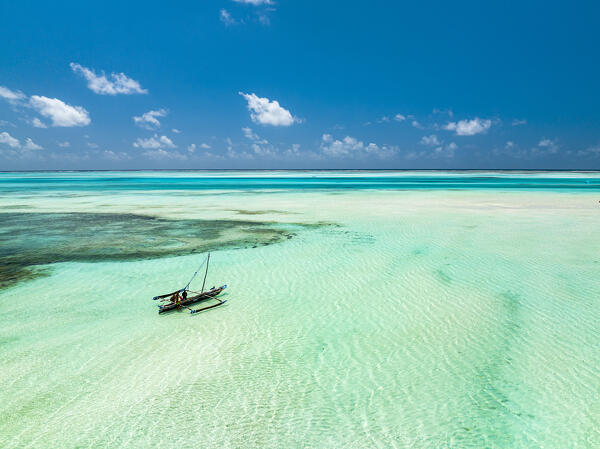 Aerial view of a dhow boat in the turquoise lagoon during  low tide, Paje, Jambiani, Zanzibar, Tanzania
