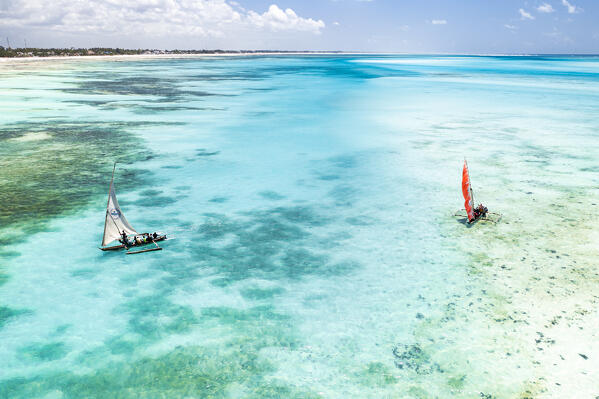 Tourists enjoying a boat trip on traditional dhow in the crystal sea, Paje, Jambiani, Zanzibar, Tanzania