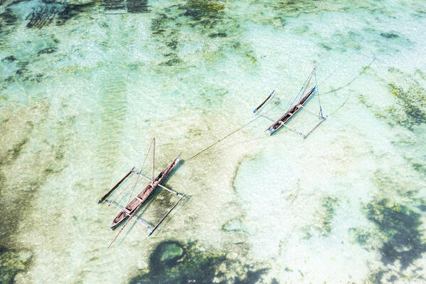 Overhead view of dhow boats moored in the emerald green water of lagoon, Paje, Jambiani, Zanzibar, Tanzania
