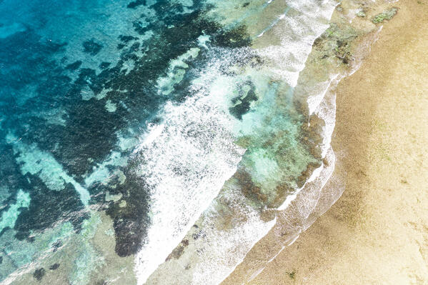 Aerial view of waves of the Indian Ocean washing an idyllic empty beach, Zanzibar, Tanzania