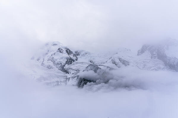 Foggy sky over snowy mountains and Lyskamm glacier, Gornergrat, Zermatt, canton of Valais, Switzerland