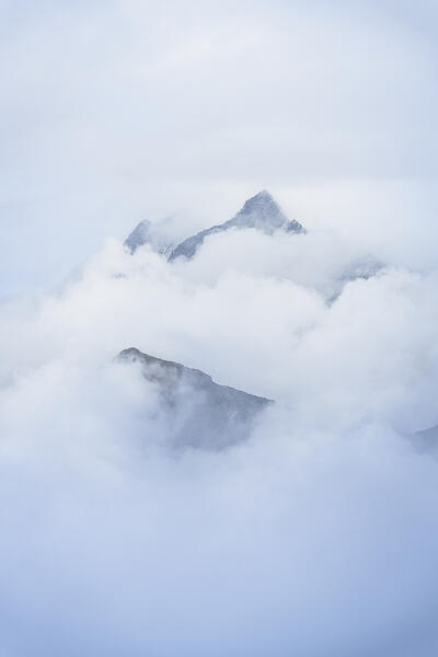 Majestic mountains emerging from fog in autumn, Gornergrat, Zermatt, canton of Valais, Switzerland