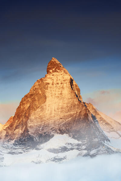 Majestic Matterhorn emerging from mist at sunrise, Gornergrat, Zermatt, canton of Valais, Switzerland