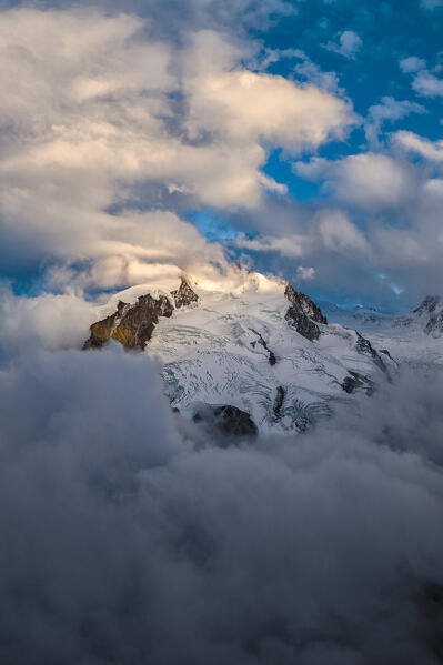 Aerial panoramic view of Monte Rosa peak covered with snow during a foggy sunrise at fall, Zermatt, Valais canton, Switzerland
