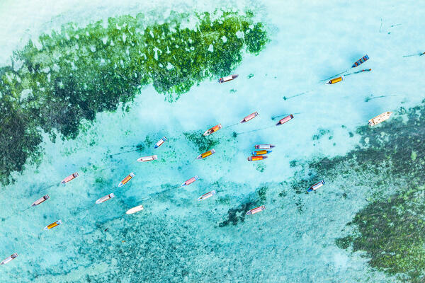 Boats moored in the turqoise clear water of the Indian Ocean, overhead view, Zanzibar, Tanzania