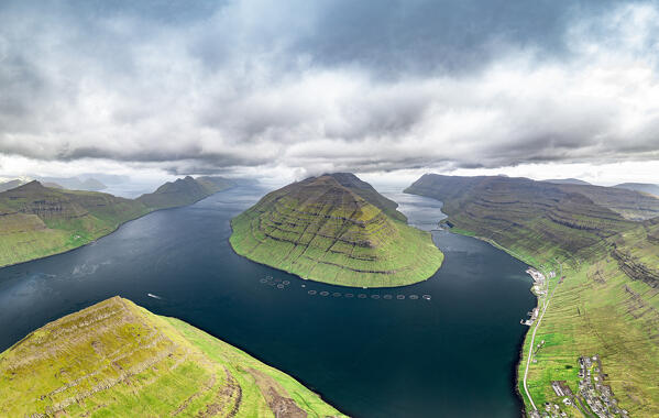 Aerial view of Kunoy Island and Klaksvik city along the fjord under storm clouds in summer, Bordoy Island, Faroe Islands