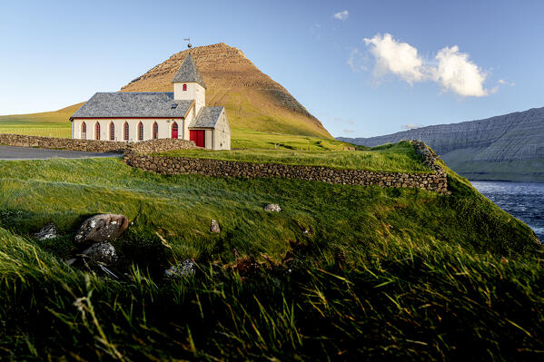 Traditional church of Vidareidi overlooking the ocean at sunset, Vidoy Island, Faroe Islands