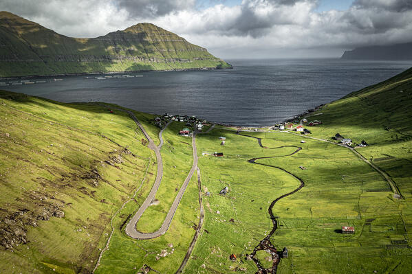 Overhead view of winding mountain road leading to the fishing village of Elduvik, Eysturoy Island, Faroe Islands