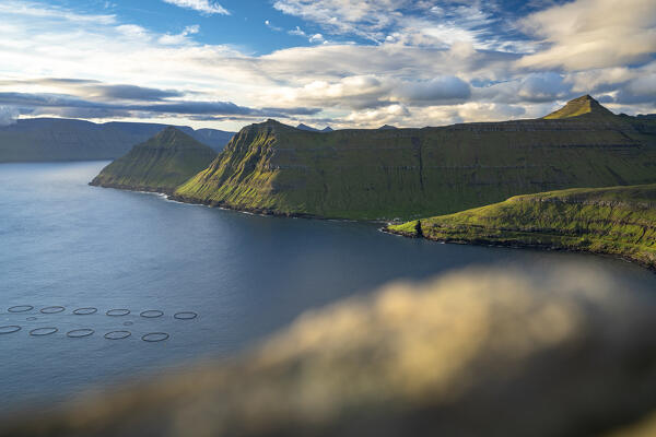 Fishing tanks in the blue water of Funningur fjord in summer, Eysturoy Island, Faroe Islands