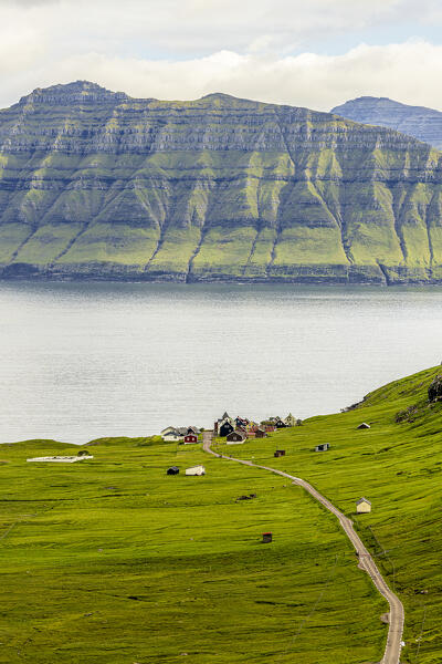 Overhead view of straight empty road to the small coastal village of Hellur,  Eysturoy Island, Faroe Islands