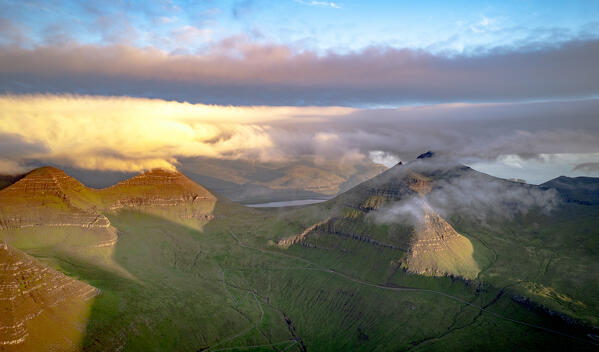 Mist at dawn over Slaettaratindur peak, highest mountain of Faroe Islands, Eysturoy Island Denmark