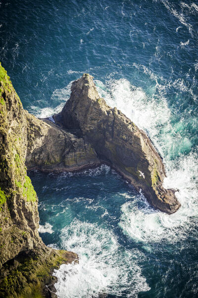 High angle view of majestic waves of the ocean breaking on cliffs, Nordradalur, Streymoy Island, Faroe Islands