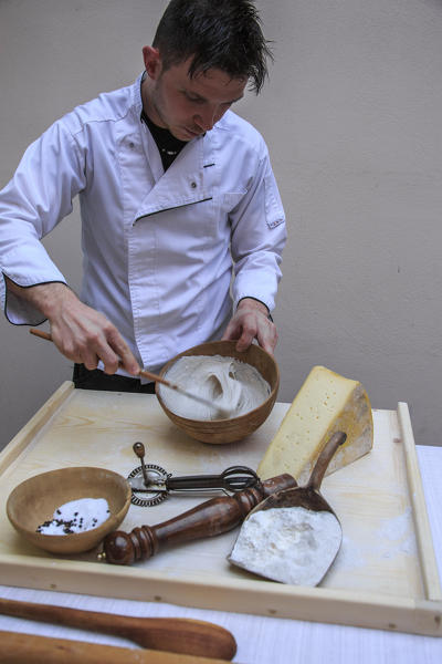 The chef preparing the mixture for Sciatt. Lombardy. Italy. Europe