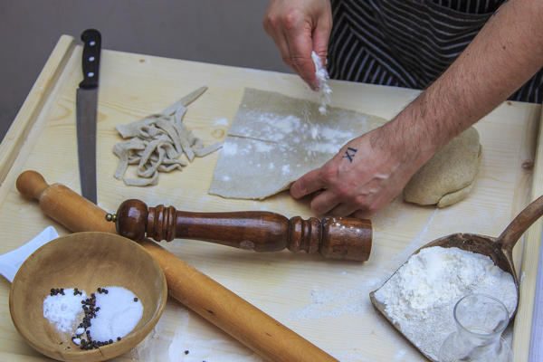 The cook flour the dough of Pizzoccheri. Lombardy. Italy. Europe