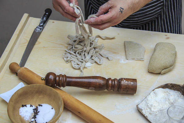 Pizzoccheri in the hands of the chef ready to cook. Lombardy. Italy. Europe