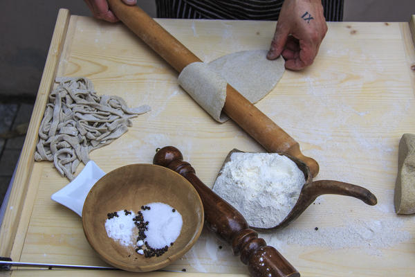 The chef pulls the Pizzoccheri dough with a rolling pin. Lombardy. Italy. Europe