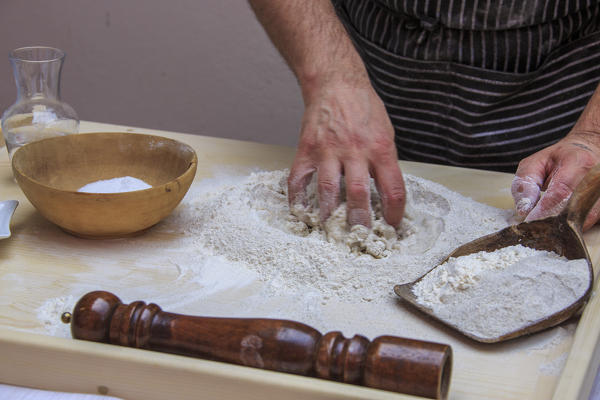 Cook knead flour and water to prepare Pizzoccheri. Lombardy. Italy. Europe