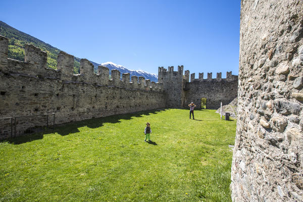 Tourists inside the walls of Castle Visconti Venosta. Grosio. Province of Sondrio. Valtellina. Lombardy. Italy. Europe