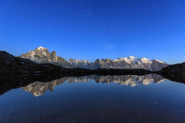 The Mont Blanc mountain range reflected in the waters of Lac de Chesery. Haute Savoie France