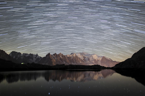 Star trail over Mont Blanc range seen from Lac de Chesery. Chamonix. Haute Savoie France