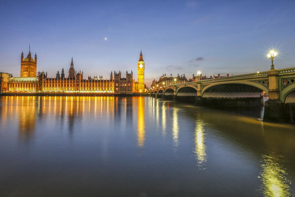 Night view of Palace of Westminster and Big Ben reflecting on Thames river. London United Kingdom Europe